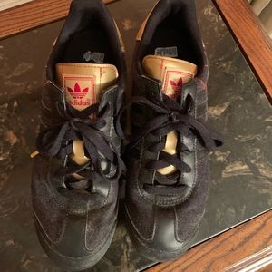 Black and gold adidas sneakers